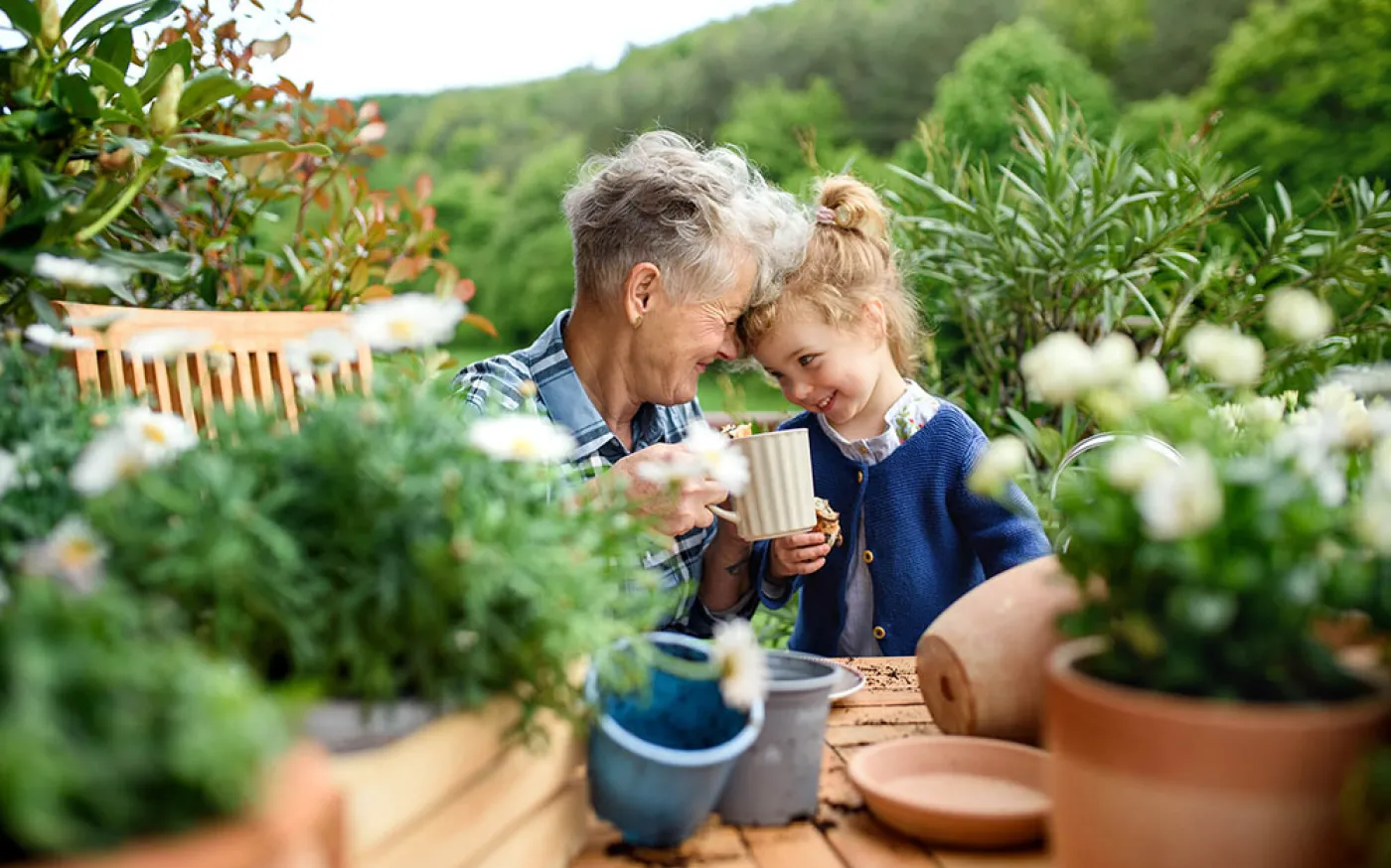 Senior grandmother with granddaughter on balcony