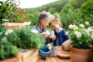 Senior grandmother with granddaughter on balcony